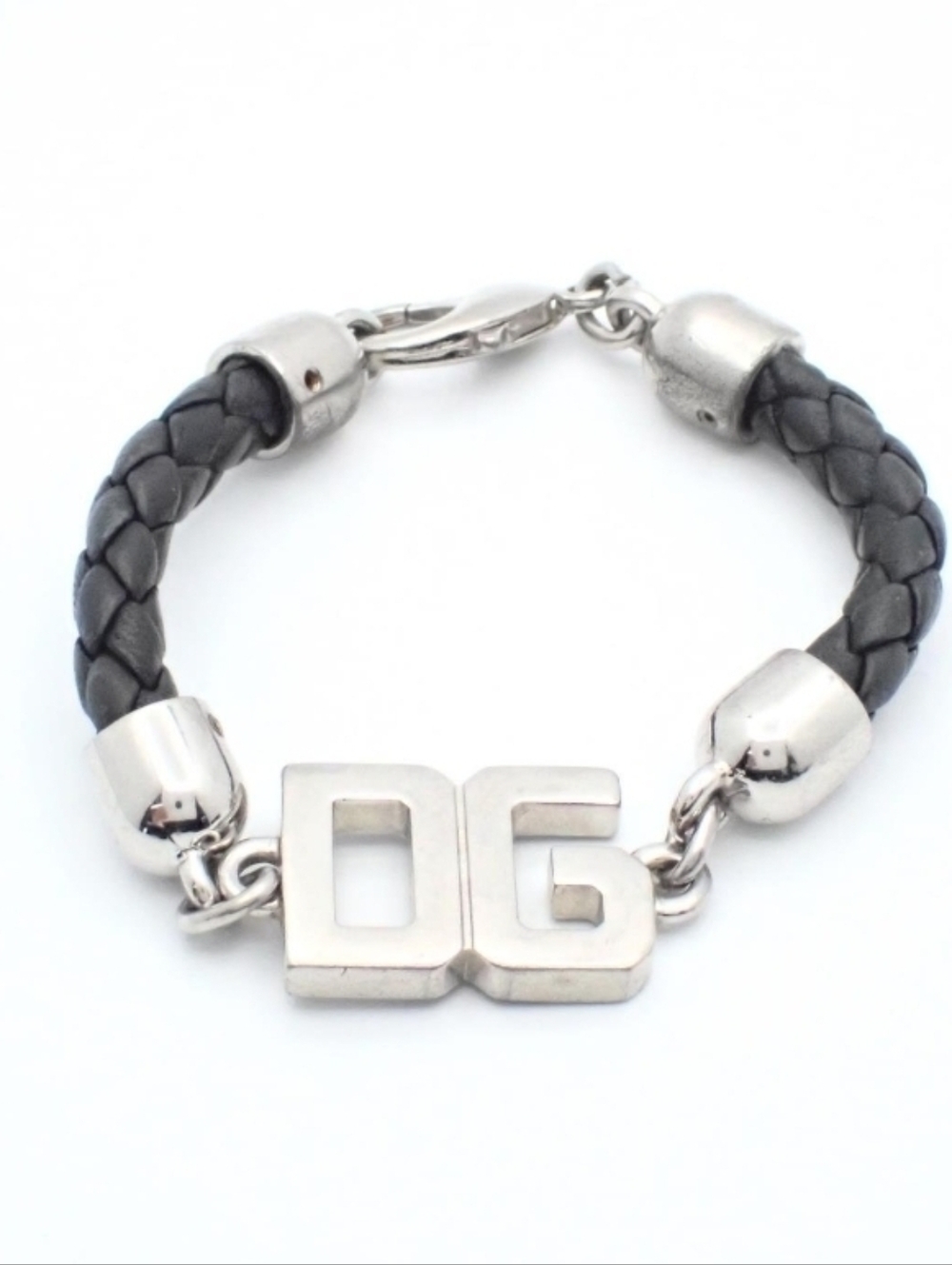 Dolce & Gabbana piece featuring a prominent "DG" logo and a braided leather stra